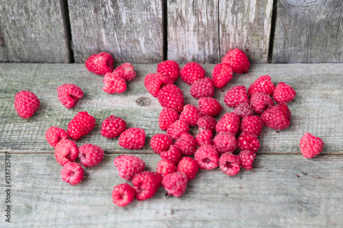 Raspberry on a wooden bench. Natural composition