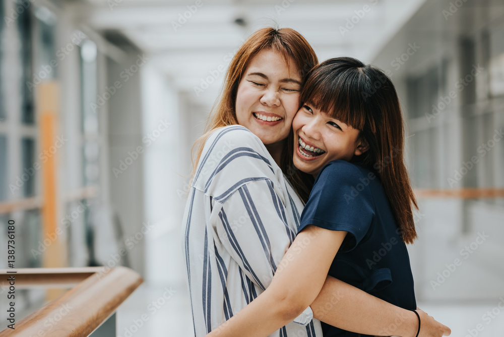 Two beautiful happy Asian girls friends laughing and hug. Friendship concept. Stock Photo