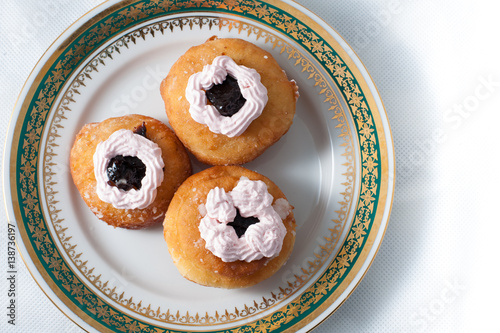 sweet donuts with cream on a plate