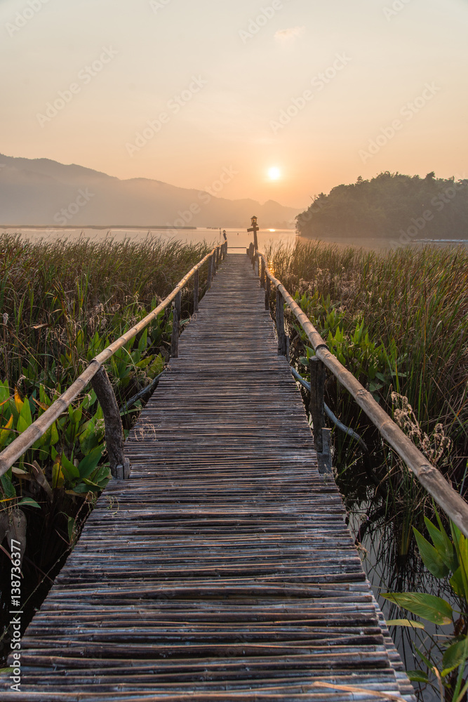 Backdrop wooden walkway lighting lake.