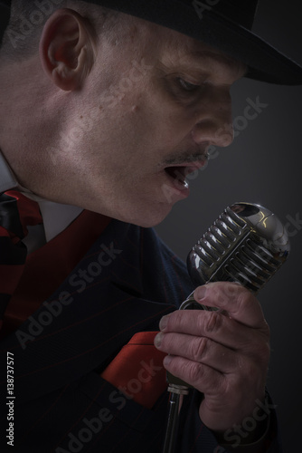 Close up portrait of a mature Jazz man singing into a microphone