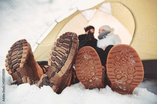 sole of winter shoes. Man and woman in camping tent photo