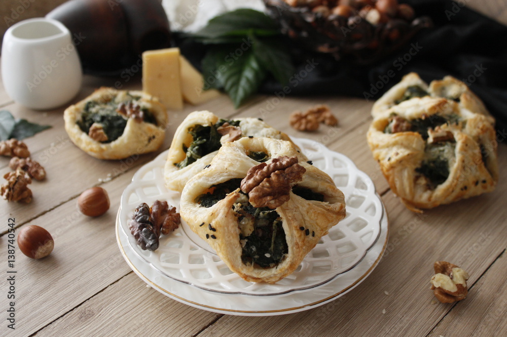 Spinach puffs with addition of cheese, walnuts and sesame seeds.Rustic style. Spinach puffs with addition of cheese, walnuts and sesame seeds.Rustic style.