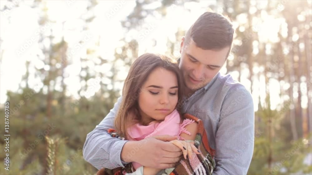 Man gently hug the girl's shoulders in the open air in the forest.Full hd video.