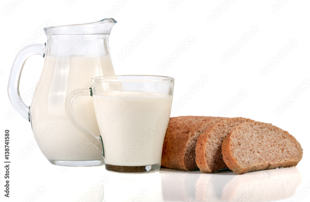 jug and glass of milk with a loaf of bread isolated on white background jug and glass of milk with a loaf of bread isolated on white background