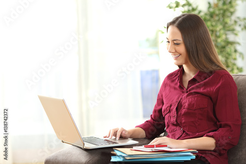 Entrepreneur working on line at home with laptop