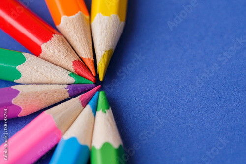 wooden colored pencils, on blue background, creative concept