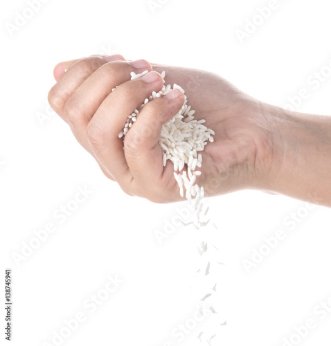 Hands dropping rice grain isolated on white background.