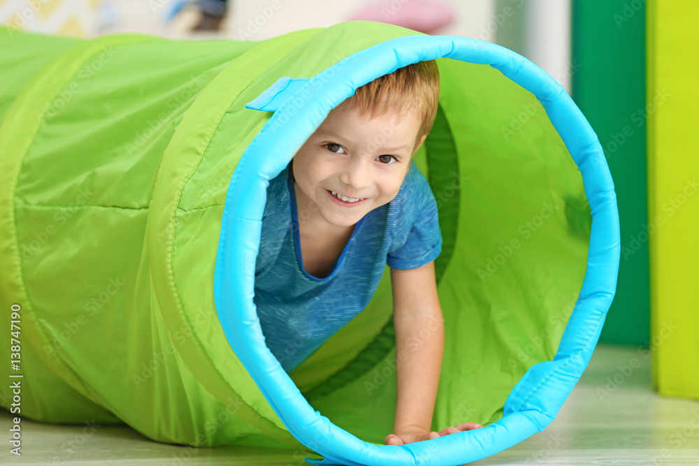 Cute little boy playing with tunnel at home Stock Photo | Adobe Stock