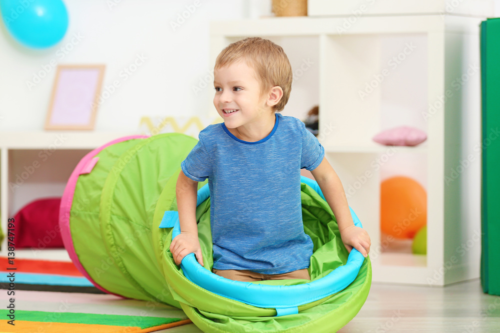 Cute little boy playing with tunnel at home Cute little boy playing with tunnel at home