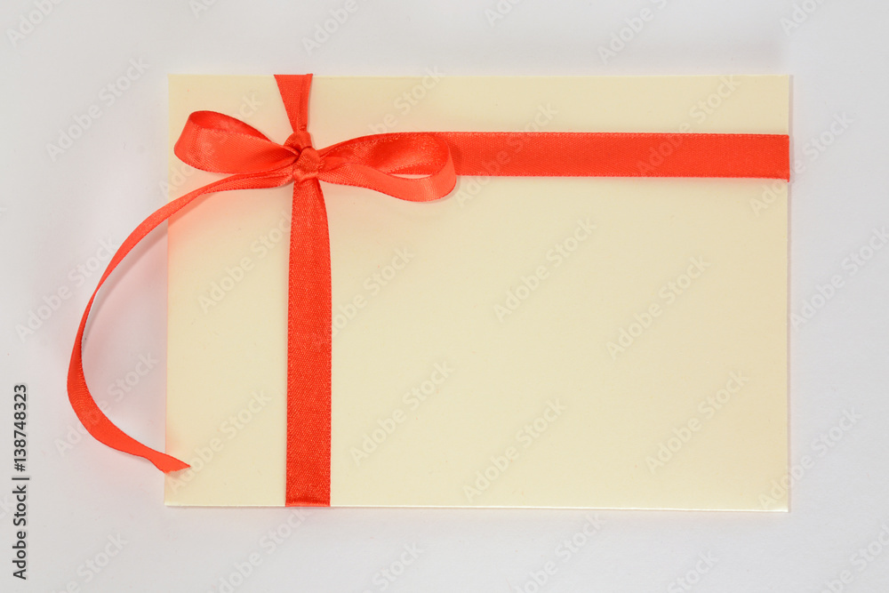 Light yellow envelope with a red ribbon on a white background Light yellow envelope with a red ribbon on a white background