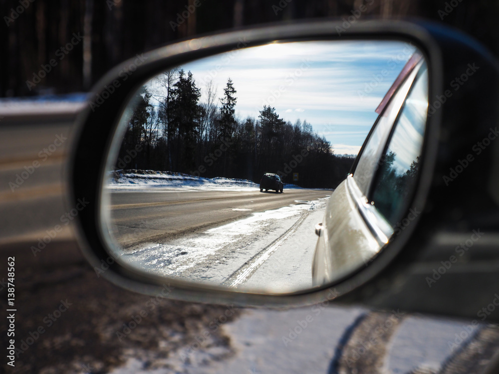 look in the rearview mirror of a car
