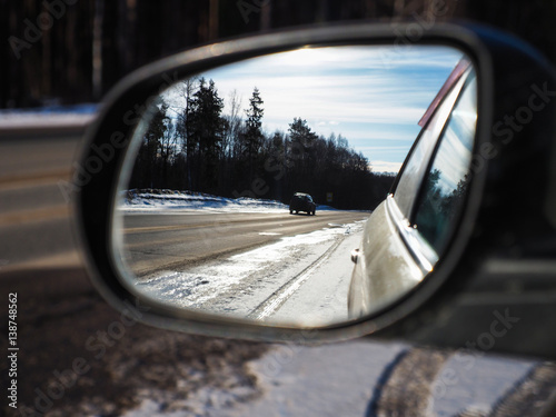 look in the rearview mirror of a car 