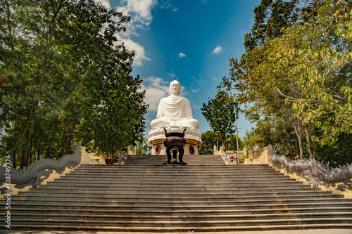 Statue of the Buddha against the blue sky. Temple of the Buddha. Vietnam, Nha Trang, Pagoda. photo