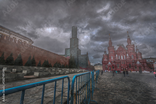 The Kremlin wall and the Red Square in uncertainty fog under gloomy clouds