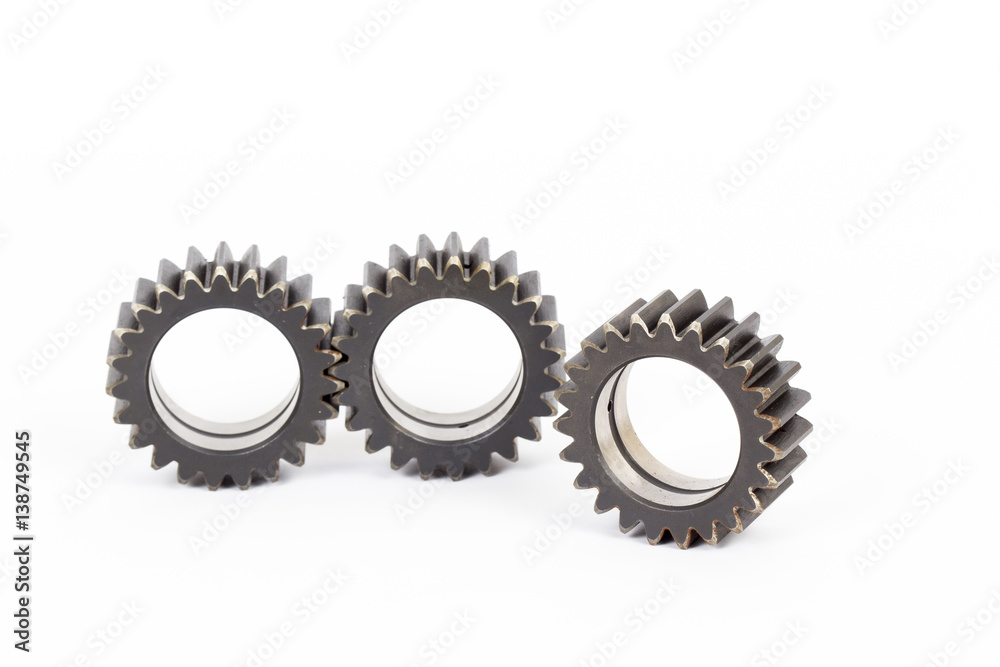 Small group of gears with their teeth engaged on a white background. Small group of gears with their teeth engaged on a white background.