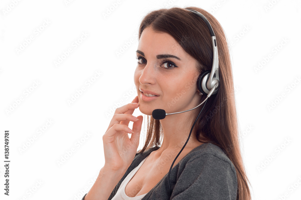 Portrait of a beautiful young girl in headphones with a microphone that looks toward isolated on white background Portrait of a beautiful young girl in headphones with a microphone that looks toward isolated on white background