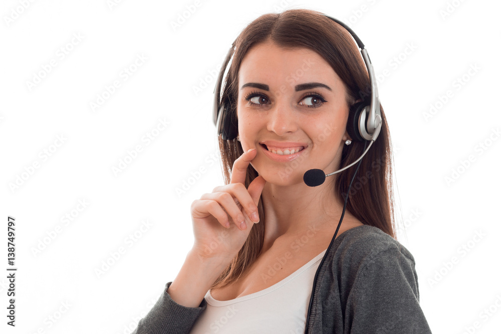 joyful young girl stands in the headphones with a microphone and looks toward isolated on a white background joyful young girl stands in the headphones with a microphone and looks toward isolated on a white background