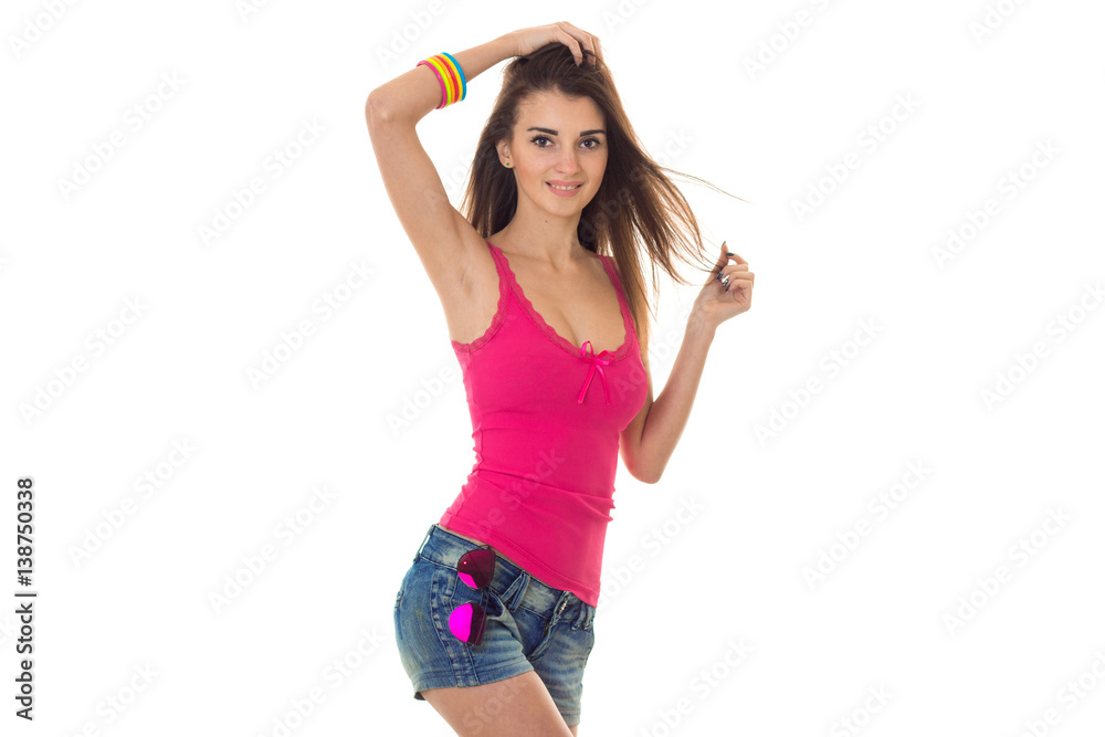 young cute girl in a bright t-shirt and short shorts with beautiful body  raised a hand up and looks into the camera Stock Photo | Adobe Stock