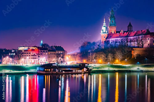 Royal castle of the Polish kings on the Wawel hill, over the Vistula river in the evening, Krakow, Poland photo