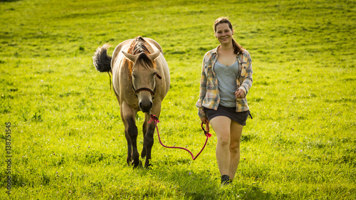 Girl with a horse on a field in Slovakian region Orava