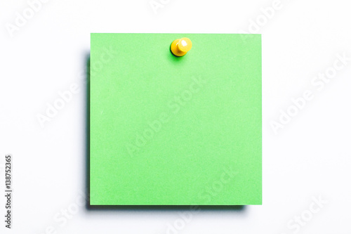 Green note pined isolated on white. Empty reminder card.