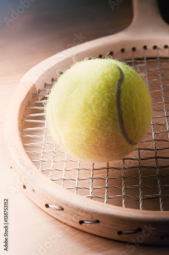 Retro Wooden Tennis Racquet with Ball on Table © Franny-Anne