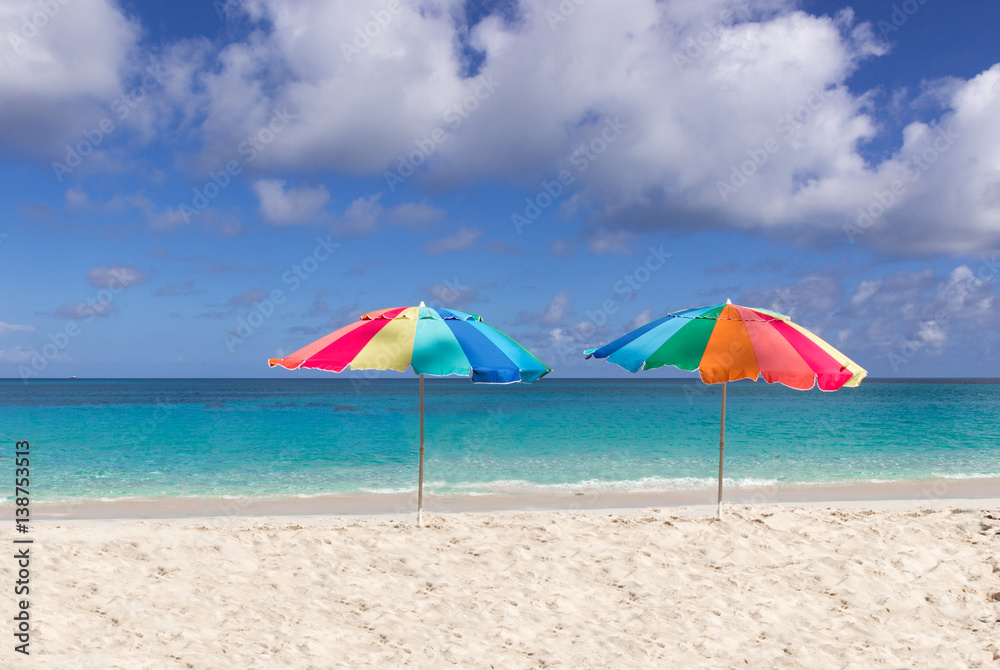 Two colorful beach umbrellas