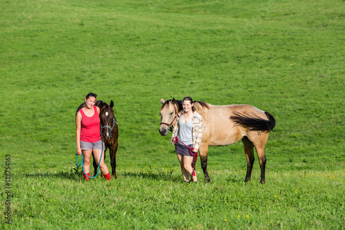 Two girls with a horse on a field in Slovakia