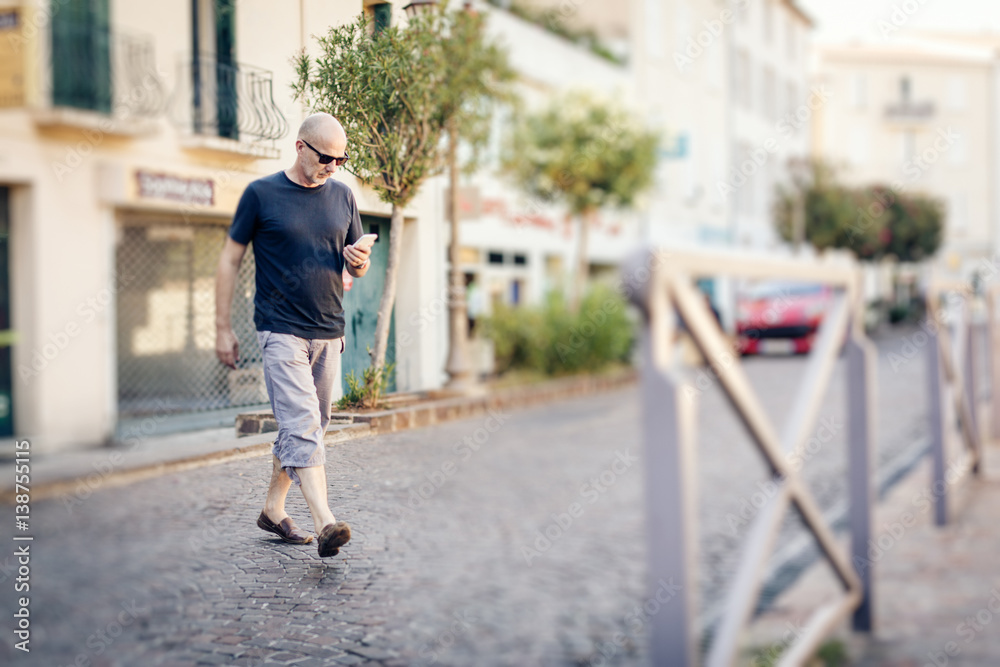 Man Crossing The Street Looking At His Phone Man Crossing The Street Looking At His Phone