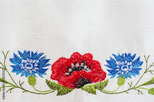 Embroidered floral pattern on a white linen towel photo