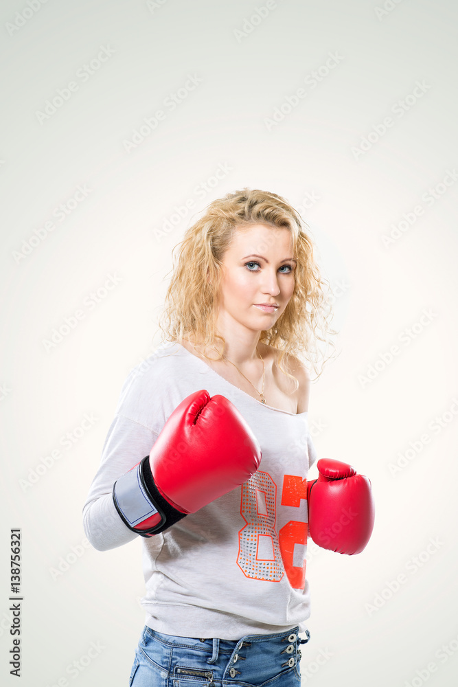 young beautiful woman in Boxing gloves on white background