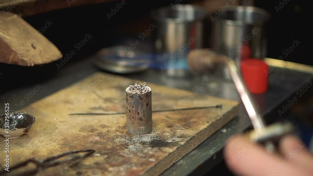 Master performs melting silver soldering iron in a special form.