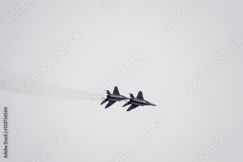 Fototapeta Naklejka Na Ścianę i Meble -  Air show in the sky above the Krasnodar airport flight school. Airshow in honor of Defender of the Fatherland. MiG-29 in the sky.