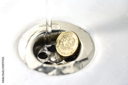 UK Pound Coin in Silver Sink Drain