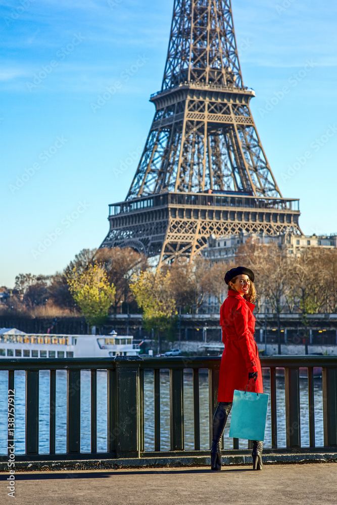 Fototapeta premium happy trendy woman standing on embankment in Paris, France