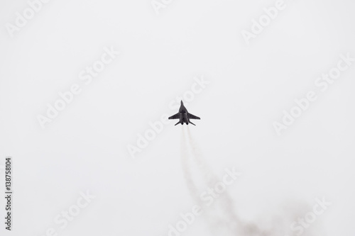 Air show in the sky above the Krasnodar airport flight school. Airshow in honor of Defender of the Fatherland. MiG-29 in the sky.