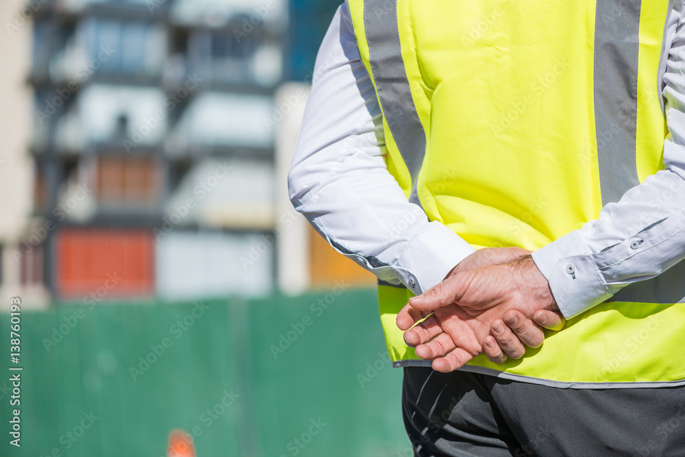 Senior foreman in glasses doing his job at building area on sunny day Senior foreman in glasses doing his job at building area on sunny day