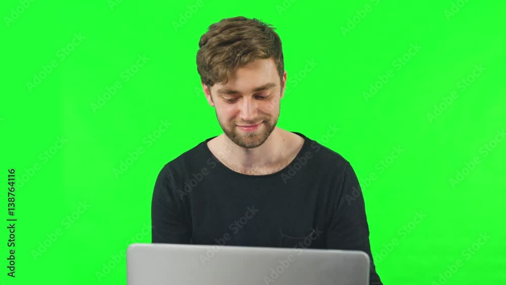 Close-up view of young man online shoping at home on pc, typing credit card number. Dolly shoot, Green Screen. Easy to key out and add your own background.