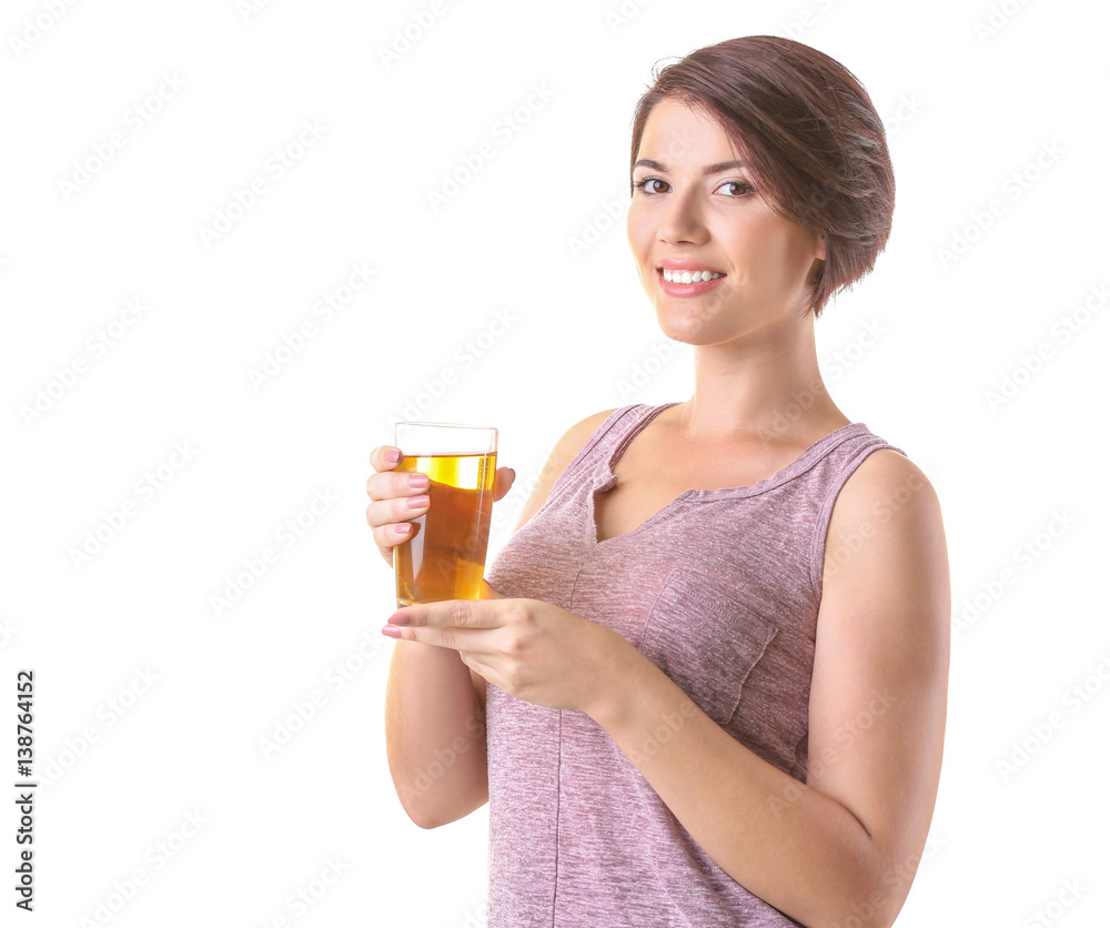 Young beautiful woman with glass of apple juice, on light background Young beautiful woman with glass of apple juice, on light background