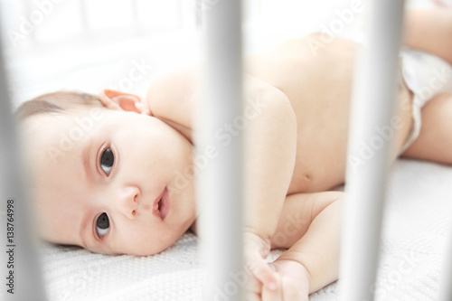 Cute little baby lying in bed