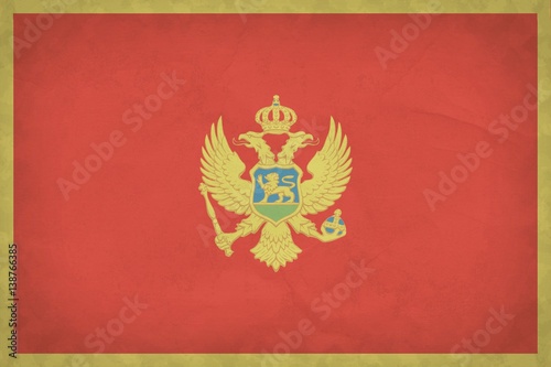 Grunge Montenegro flag pattern on crumpled kraft paper