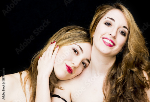 Two beautiful women Portrait over Black Background