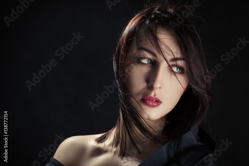 sensual woman with bare shoulders on black background
