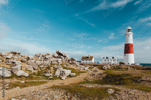 Lighthouse at Portland, Dorset, England on summer day with blue sky photo