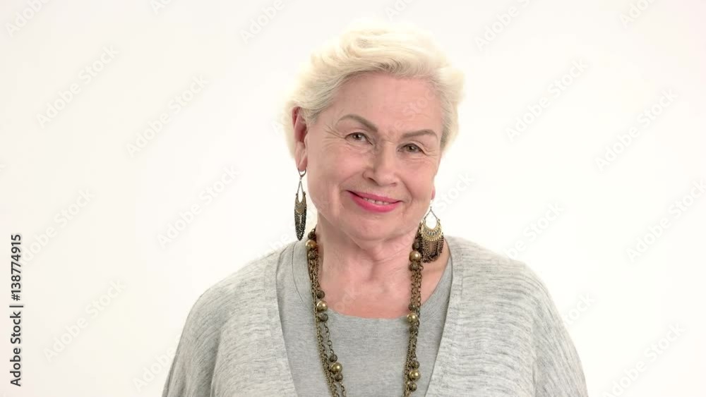 Smiling elderly female isolated. Senior woman with happy face. Good health and positive mindset. Smiling elderly female isolated. Senior woman with happy face. Good health and positive mindset.