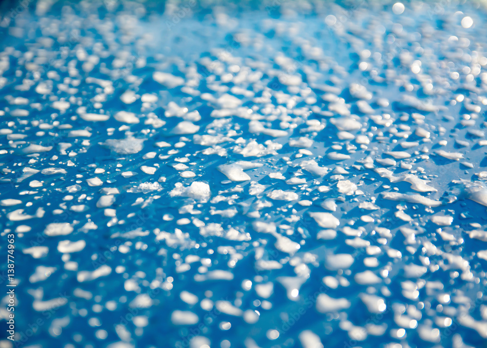 Obraz premium the snow melts on a blue background in the sun