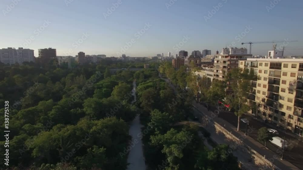 Aerial - Valencia view with green park and car traffic on the road with buildings alongside, Spain Aerial - Valencia view with green park and car traffic on the road with buildings alongside, Spain