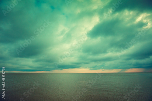 quiet calm sea with the cloudy sky at sunset