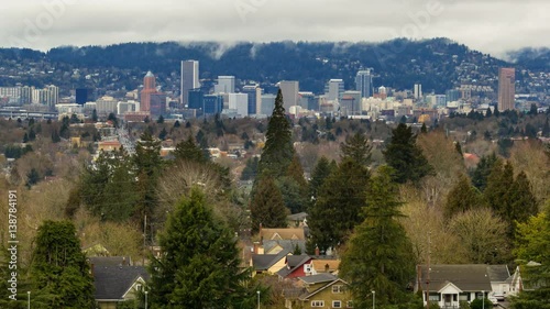 Time lapse of moving white clouds over Portland OR cityscape and residential neighborhood homes from Mt. Tabor 4k uhd 4096x2304